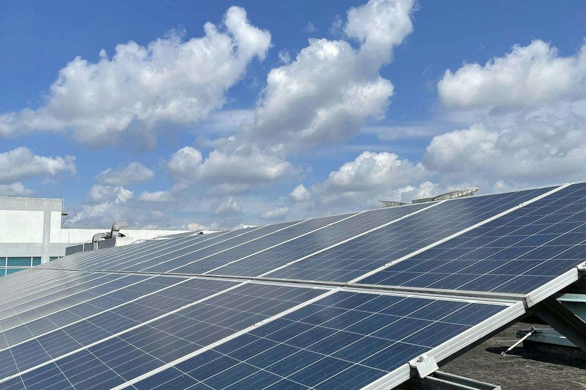 Rooftop solar panels under a blue sky
